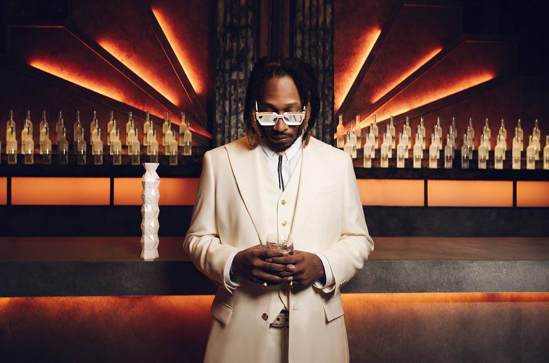 Global music icon Future holding a glass of Belvedere 10 in front of the Belvedere Bar.