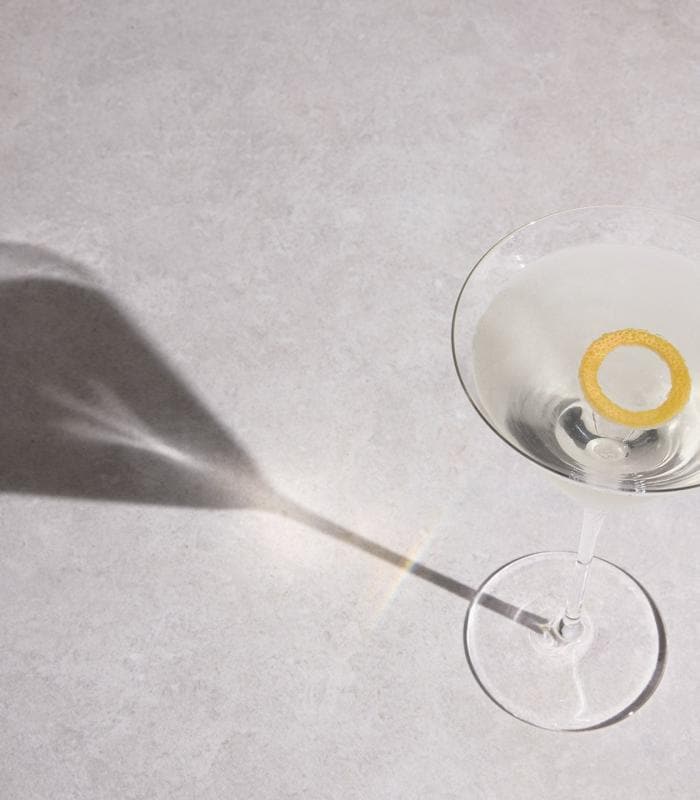 The Apex Martini cocktail with a round-cut grapefruit garnish, Formula 1® serve