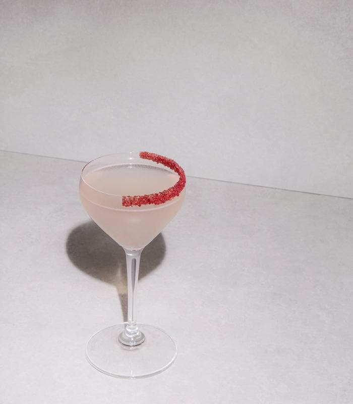 Fast Lane Lychee cocktail with a red sugar rim, Formula 1® serve