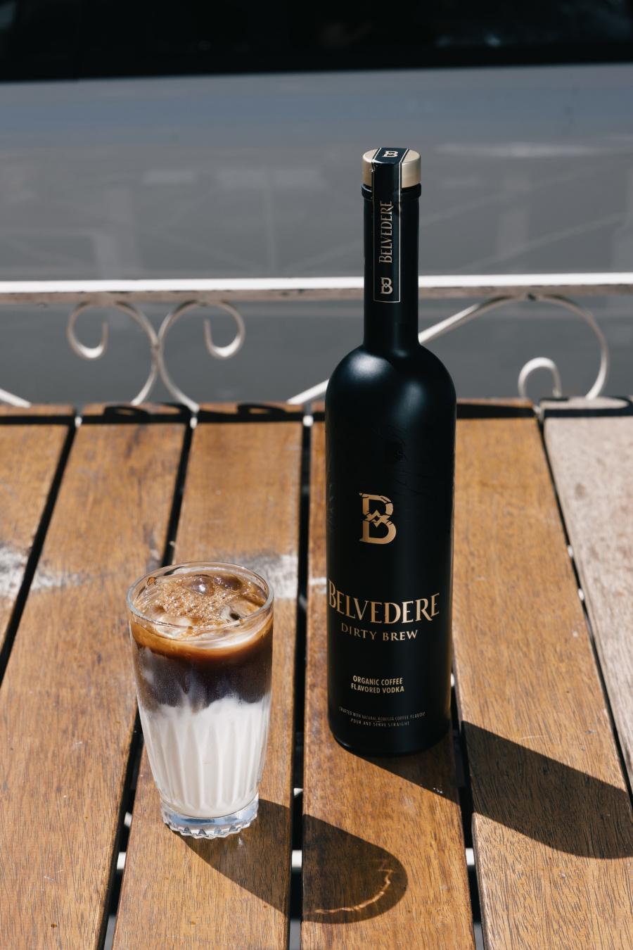 Belvedere Dirty Brew bottle and an iced Dirty Brew cocktail on a wooden table