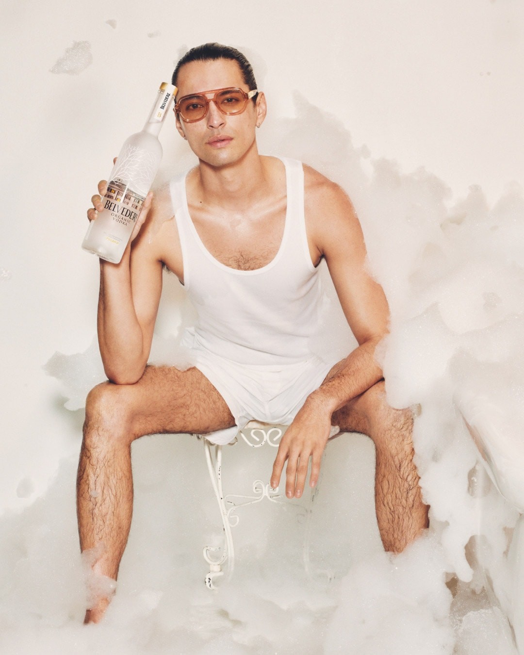 Belvedere and Tyler Mitchell - Man sitting on a chair holding a Belvedere Organic bottle